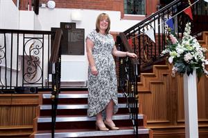 Lisa Selby standing on staircase