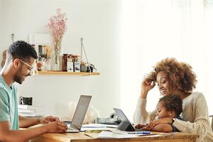 Parents and a child sitting at a desk