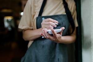Hospitality worker holding a notepad and a pen