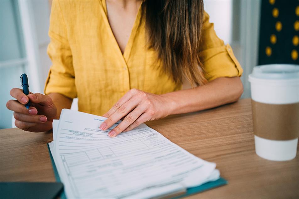  a woman filling in a form at a desk