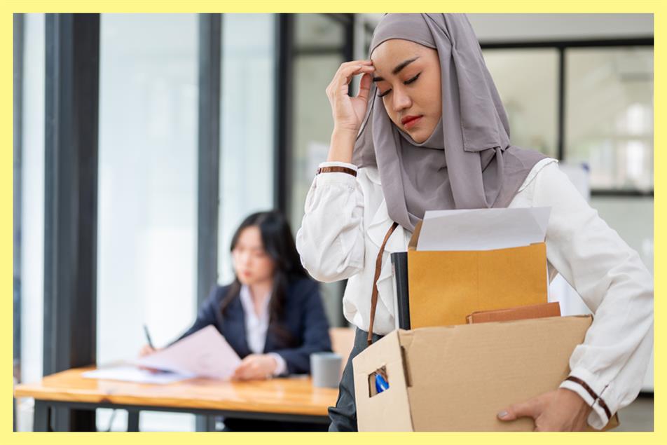 Woman leaving office with possessions 