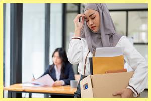 Woman leaving office with possessions 