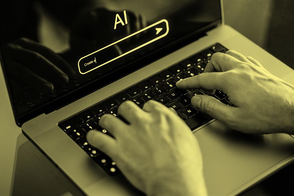 Close up of hands typing on a laptop with AI on the screen