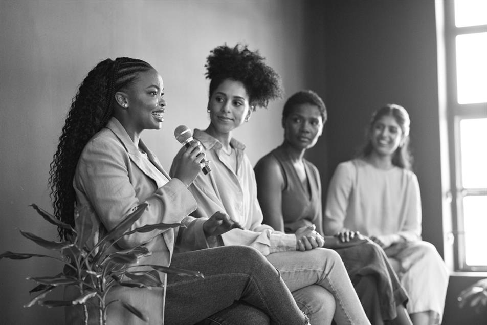 colleagues listening to confident businesswoman 