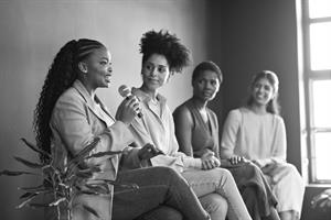 colleagues listening to confident businesswoman 