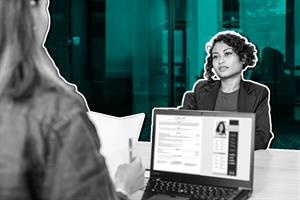 Two people sat opposite each other with a laptop