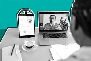 Person sat at a desk in front of a laptop and pad