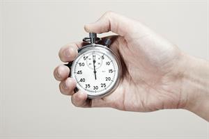 a hand holding a stopwatch