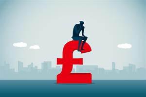 Person sitting on a large pound sign