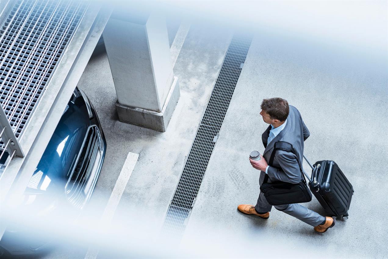 Ariel shot of businessman walking with a suitcase