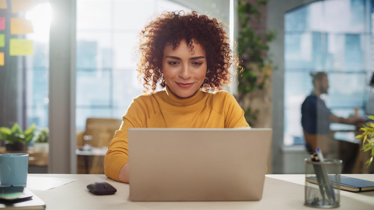 Happy woman working at laptop