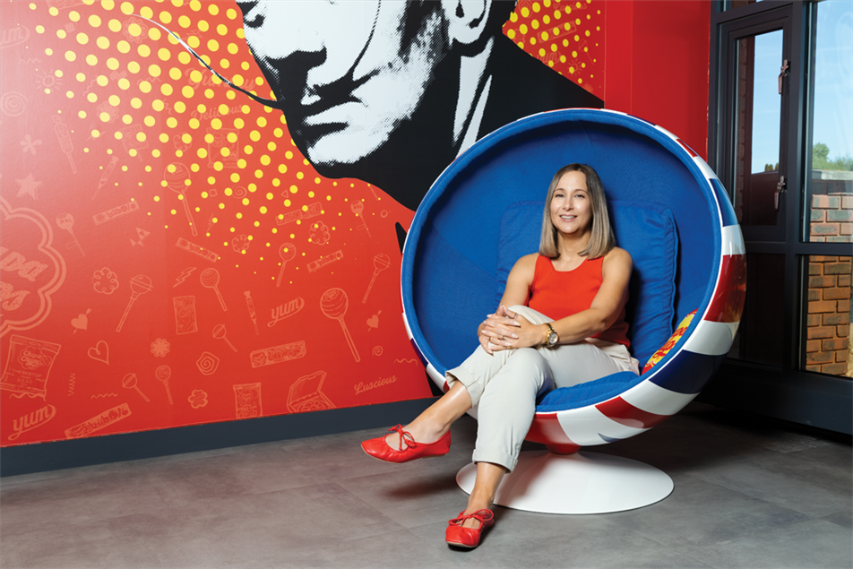 Emma Locke sitting on round chair in colourful office