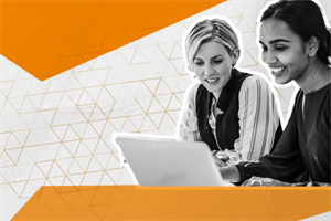 Two people sat looking at a laptop