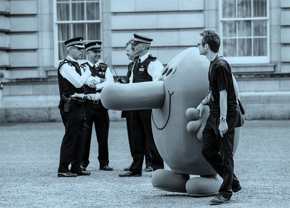 Person in Mr Nosey costume with police officers