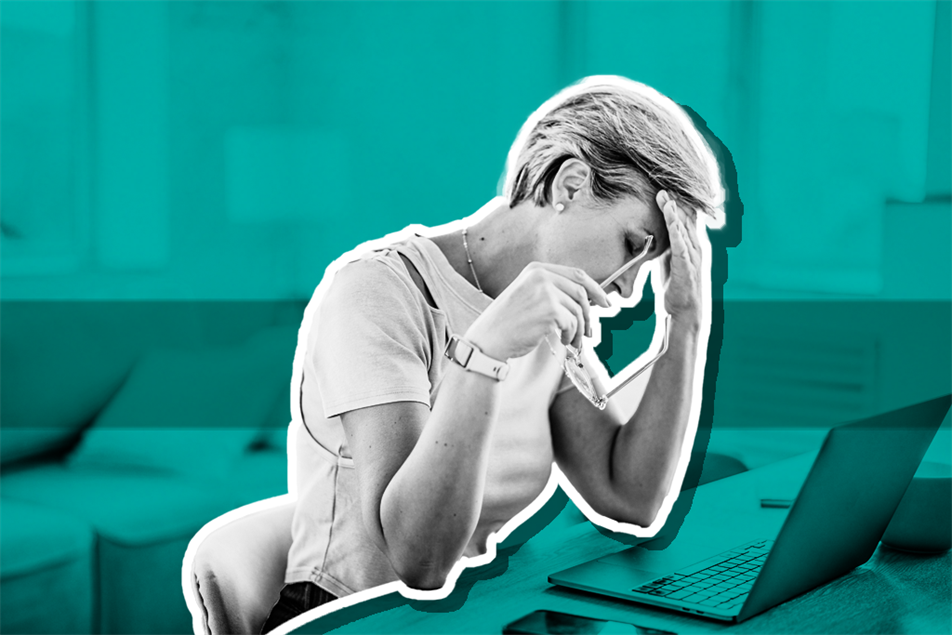 Woman with head in hand at desk