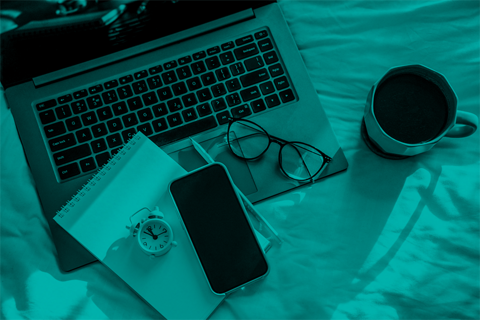 Laptop, notepad, mobile, glasses, alarm clock and mug