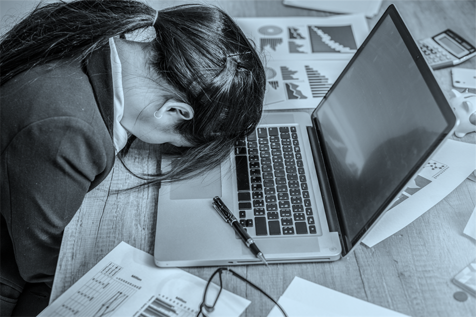 Person lying their head on a laptop