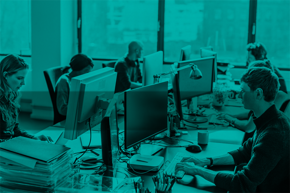 Group of people sat at desks with computers