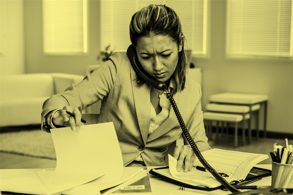 Person sat at a desk on the phone