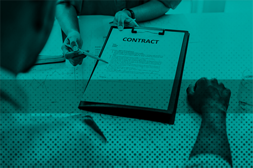 Close up of someone pointing a pen at a contract