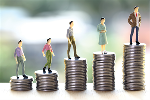 Plastic figures standing on stacks of coins