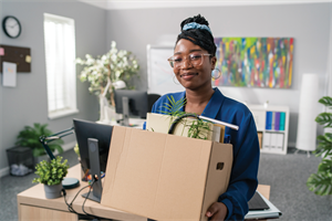 Person carrying cardboard box in an office