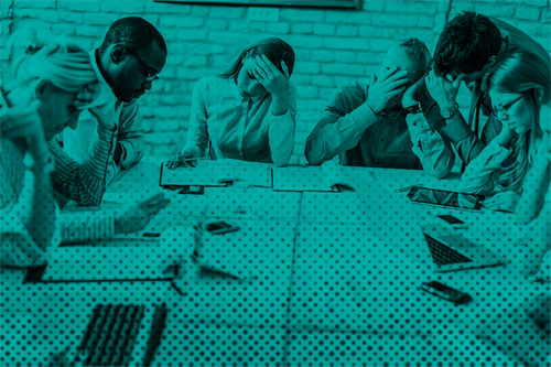 Stressed group of people sat around a table