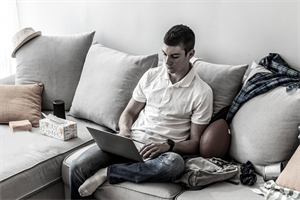 Person sitting on a messy sofa
