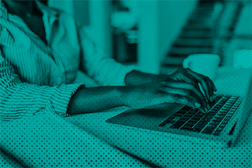 Close up of someone typing on a laptop