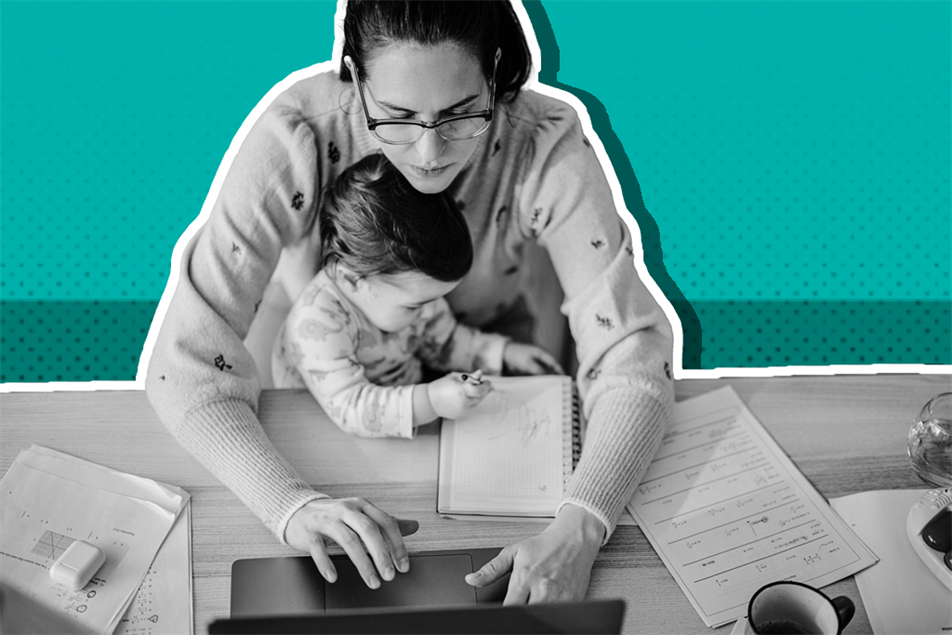 Woman working while caring for child