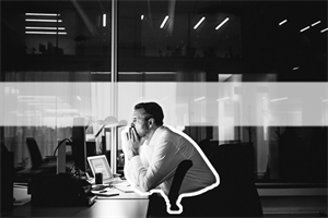 Person sat in an office at night