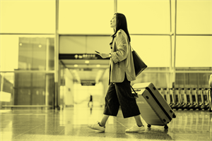 Person walking while pulling a suitcase