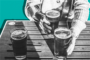Close up of someone holding pints of beer