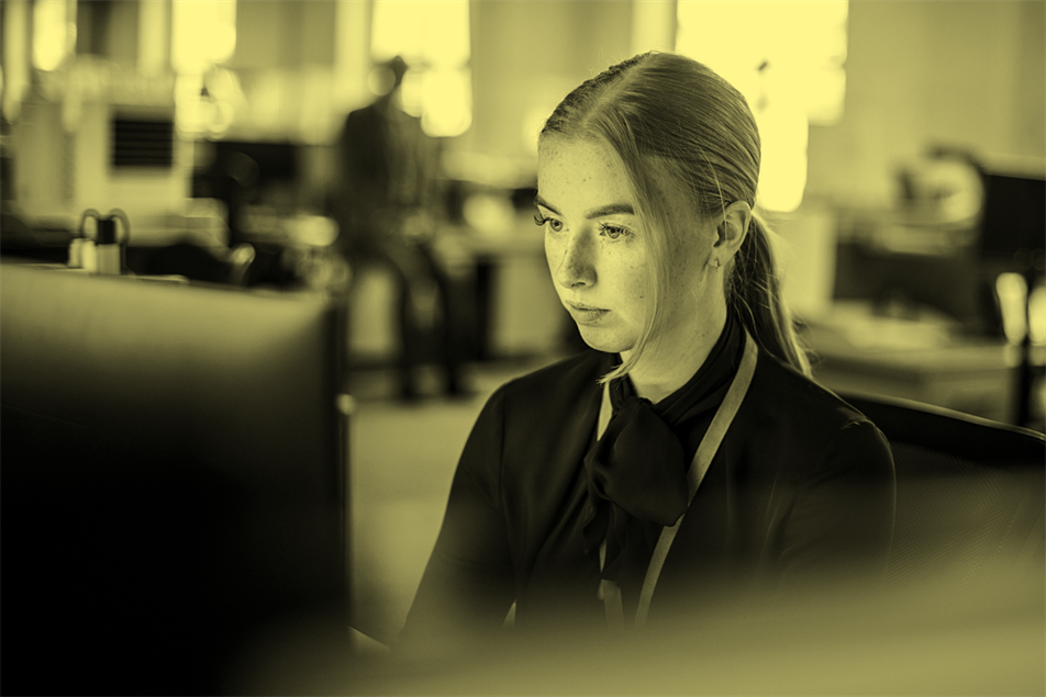 Female intern works at a computer