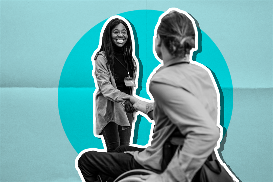 standing lady shaking hands with person in a wheelchair