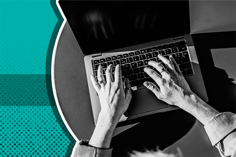 Close up of hands typing on a laptop
