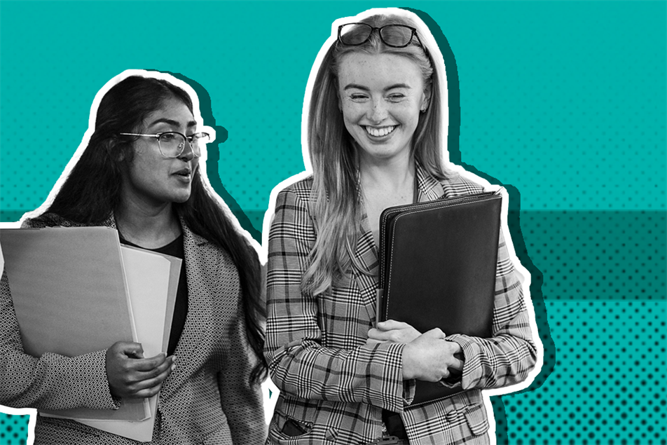Two people holding folders and smiling