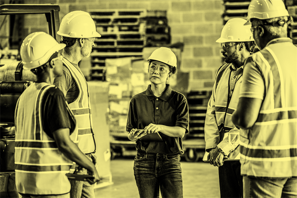Agency workers standing in front of warehouse manager
