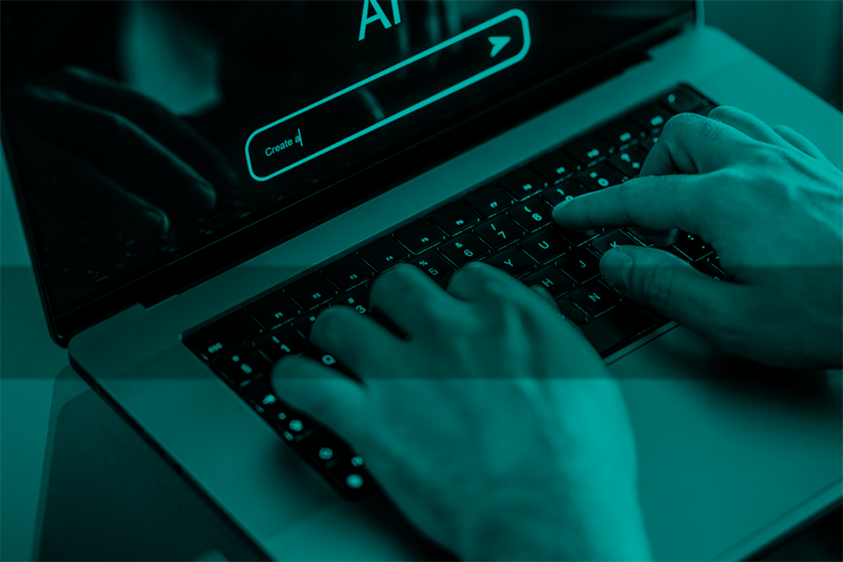 Close up of hands typing on a laptop with AI on the screen