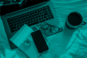 Laptop, notepad, mobile, glasses, alarm clock and mug