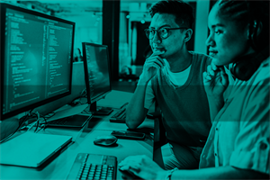 Two people sat in front of a computer screen