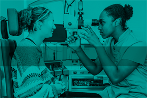 Optician observing patient's eyes