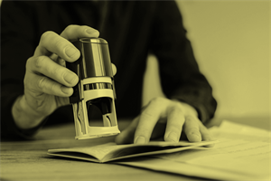 Close up of someone stamping a passport