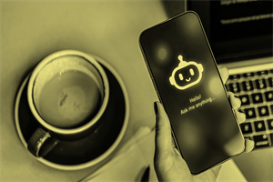 Close up of a mobile with an AI bot on it next to a cup and saucer