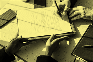 Close up of someone signing a document