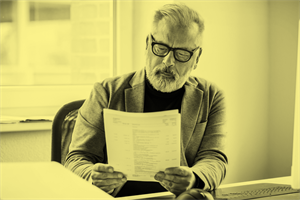 Man holding and looking at papers