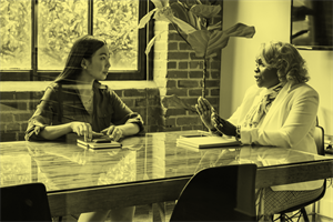 Two people sat at a desk