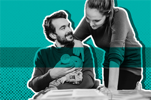 Man feeding a baby with woman watching