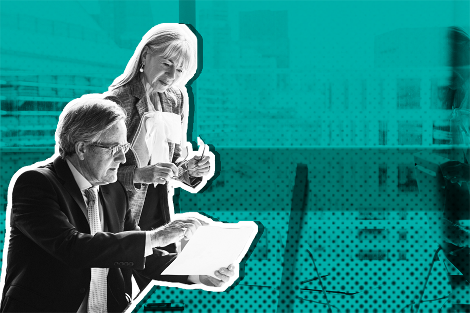 Two people in office talking