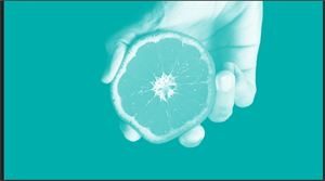 citrus fruit being squeezed